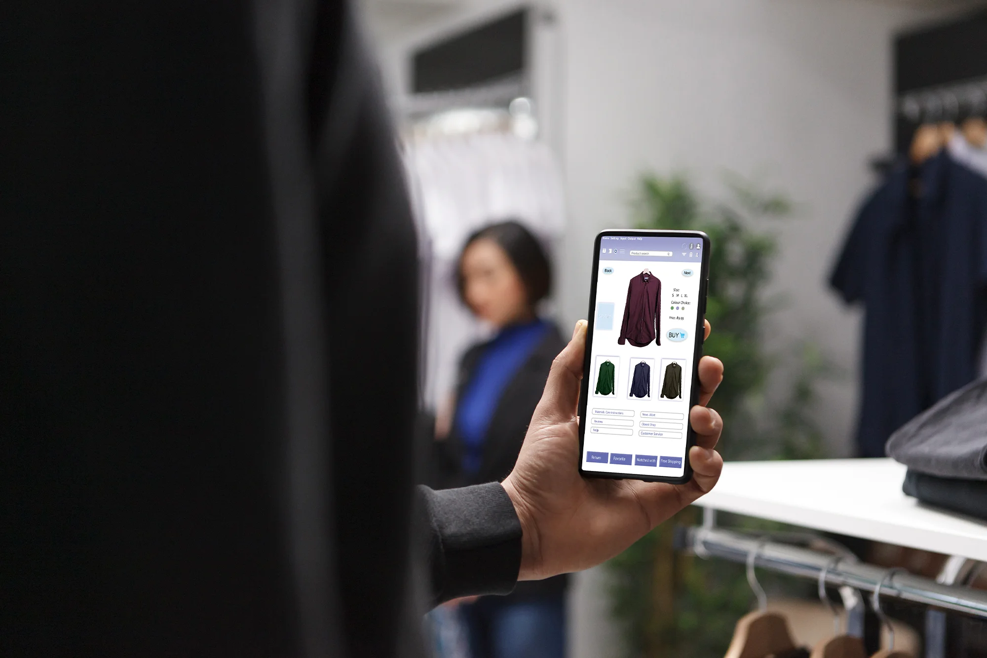 Woman using smartphone visual search app to scan clothing item in retail store